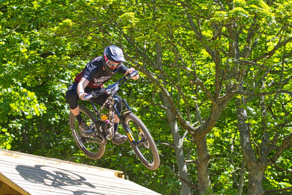Competitor taking off from ramp enduro world series