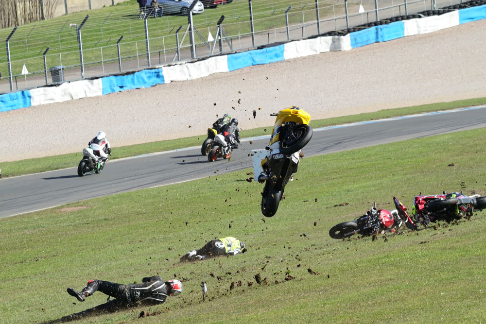 Karl Fosters Yamaha goes airborne, other motorcycles sliding on the grass