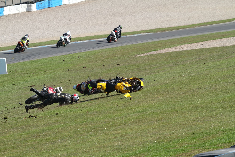 Motorcycles come to rest as racing carries on